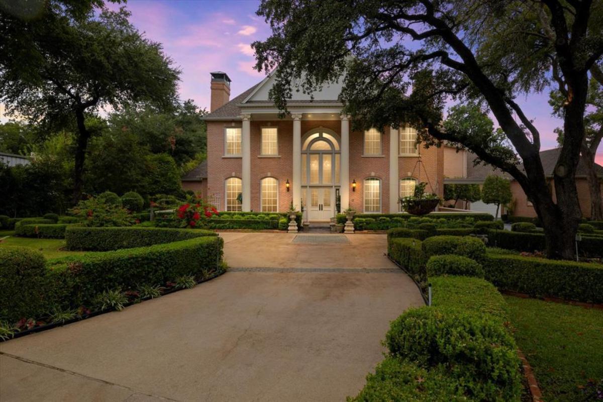 Front view of the mansion with spacious driveway.