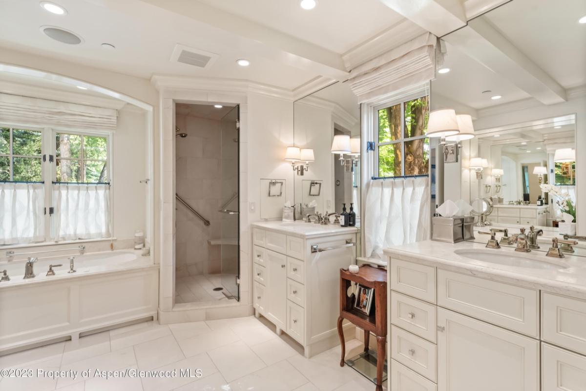 Bathroom with a sink, mirror, soaking tub and walk-in shower.