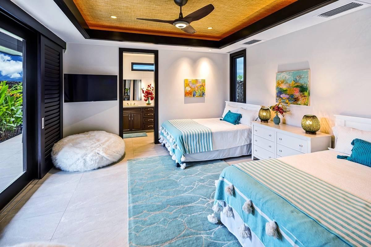 Bedroom with two beds, ceiling fan and custom lights.