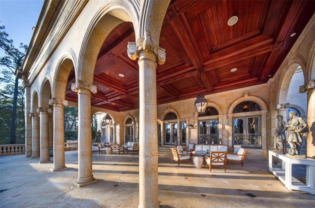 Covered patio with chairs and tables.