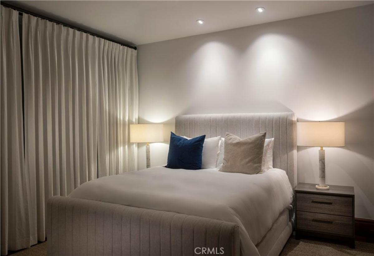 Bedroom with a large bed and custom lights.