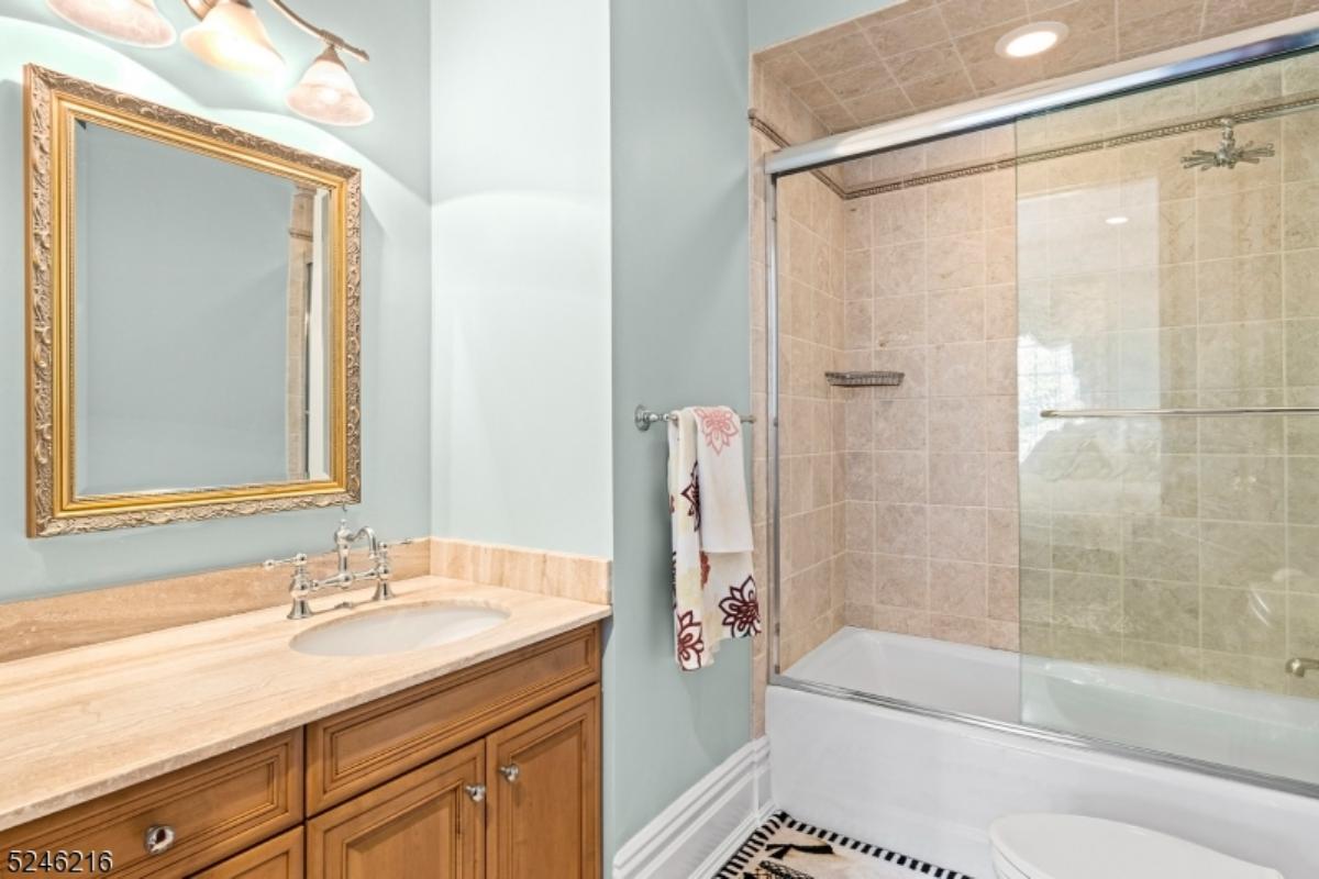 Bathroom with a sink, mirror, soaking tub, shower and a toilet.