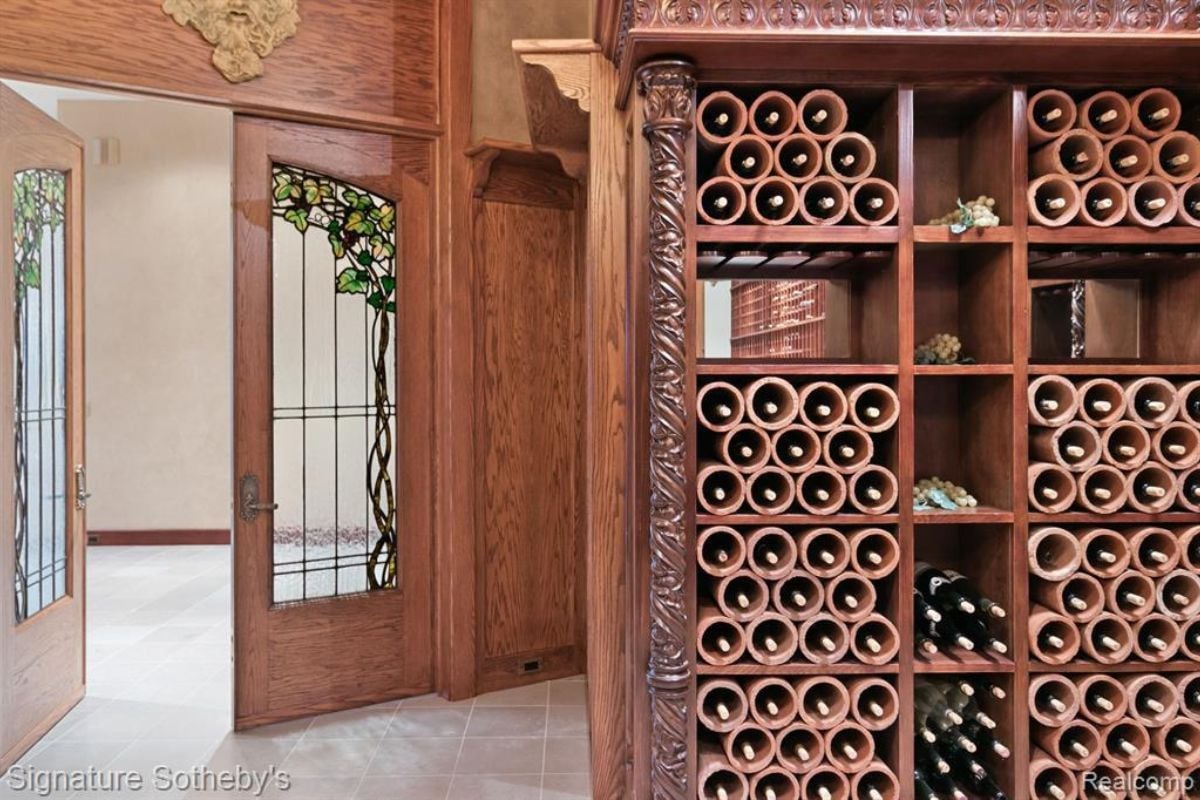 A wine cellar with cabinets, a wine rack, and shelves.