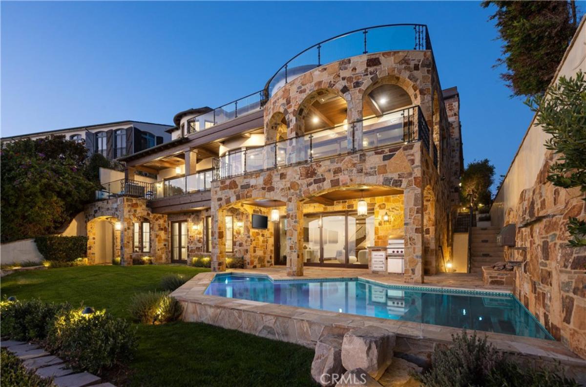Rear view of the property with a pool.