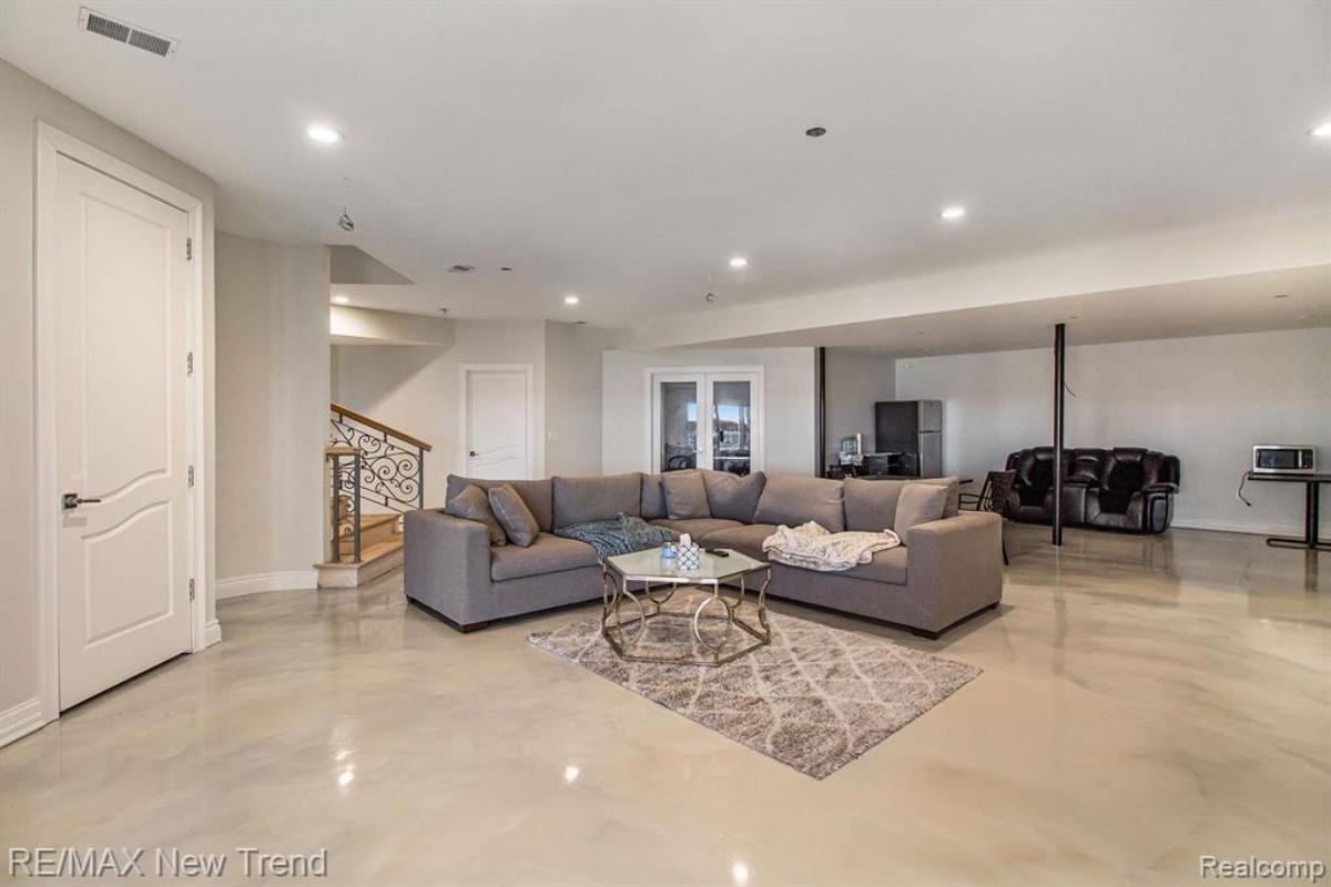 Living room with a couch and custom lights.