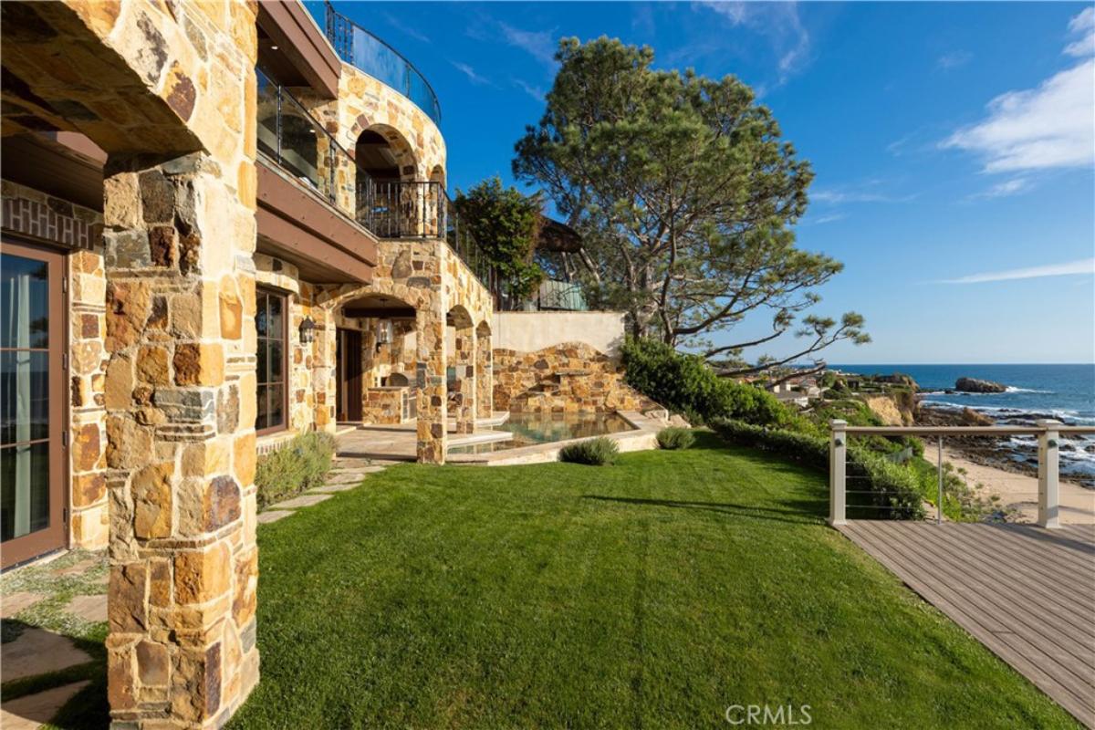 Backyard with a green lawn overlooking the ocean.