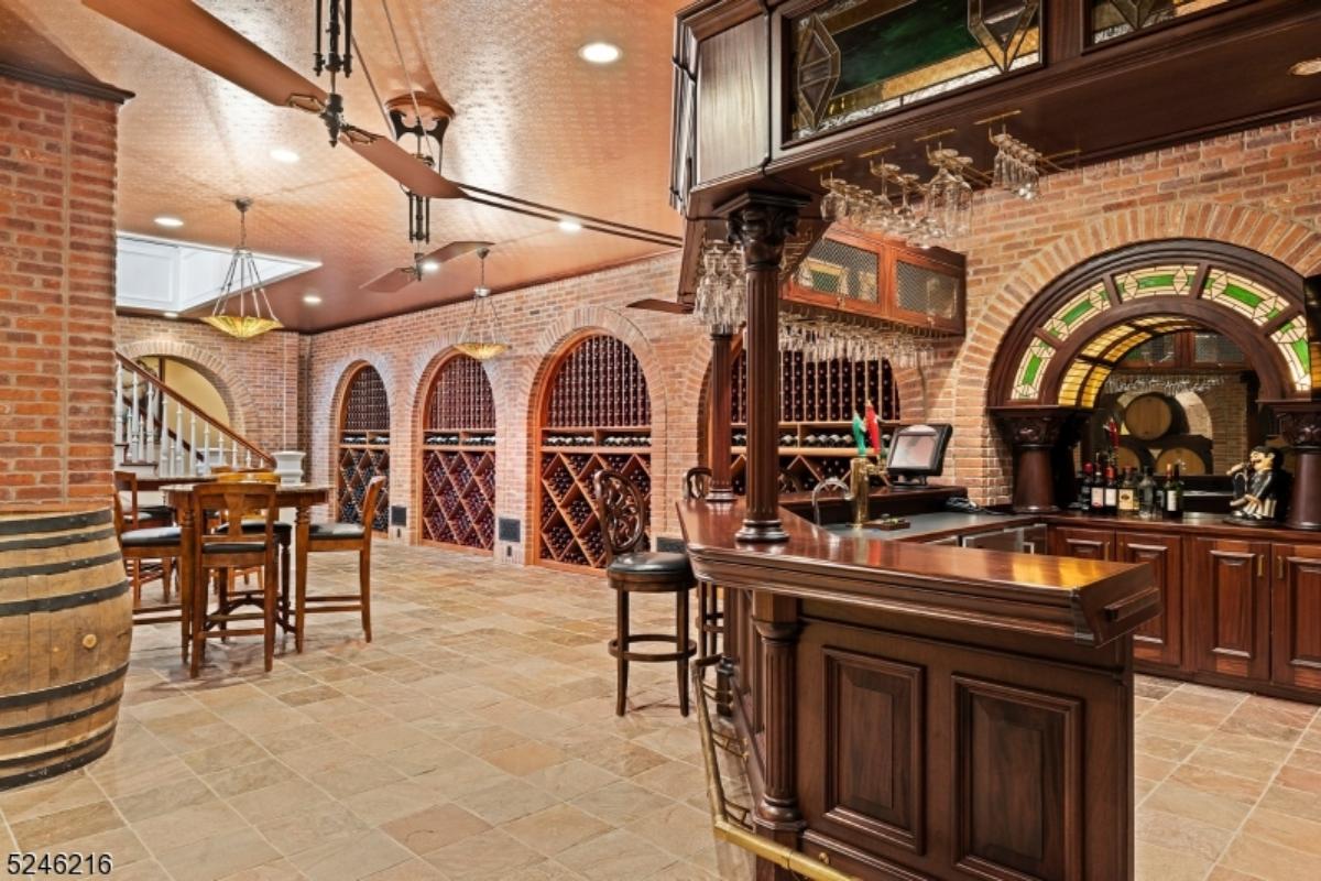 Bar with a wooden table. chairs and custom lights.
