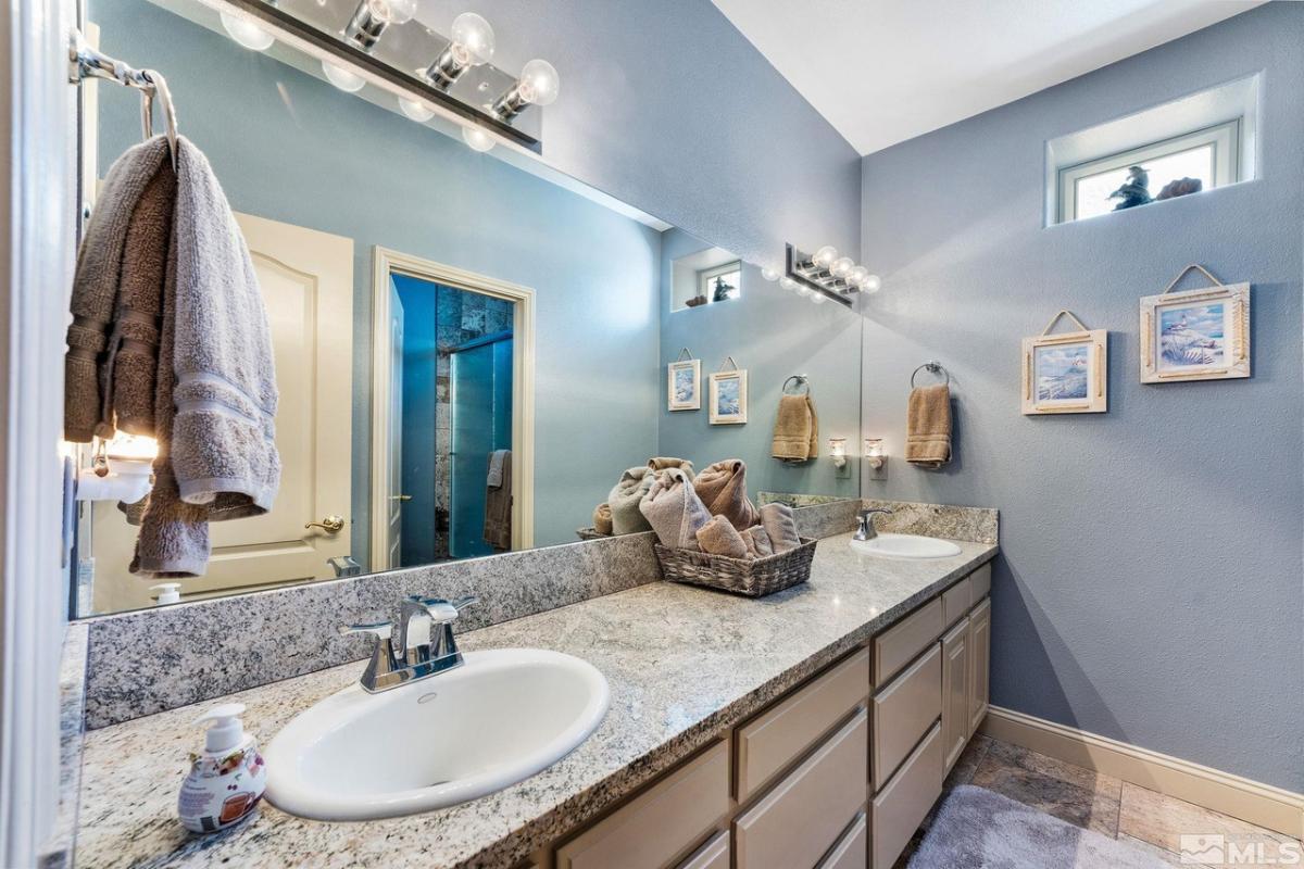 Bathroom with dual sinks and a mirror.