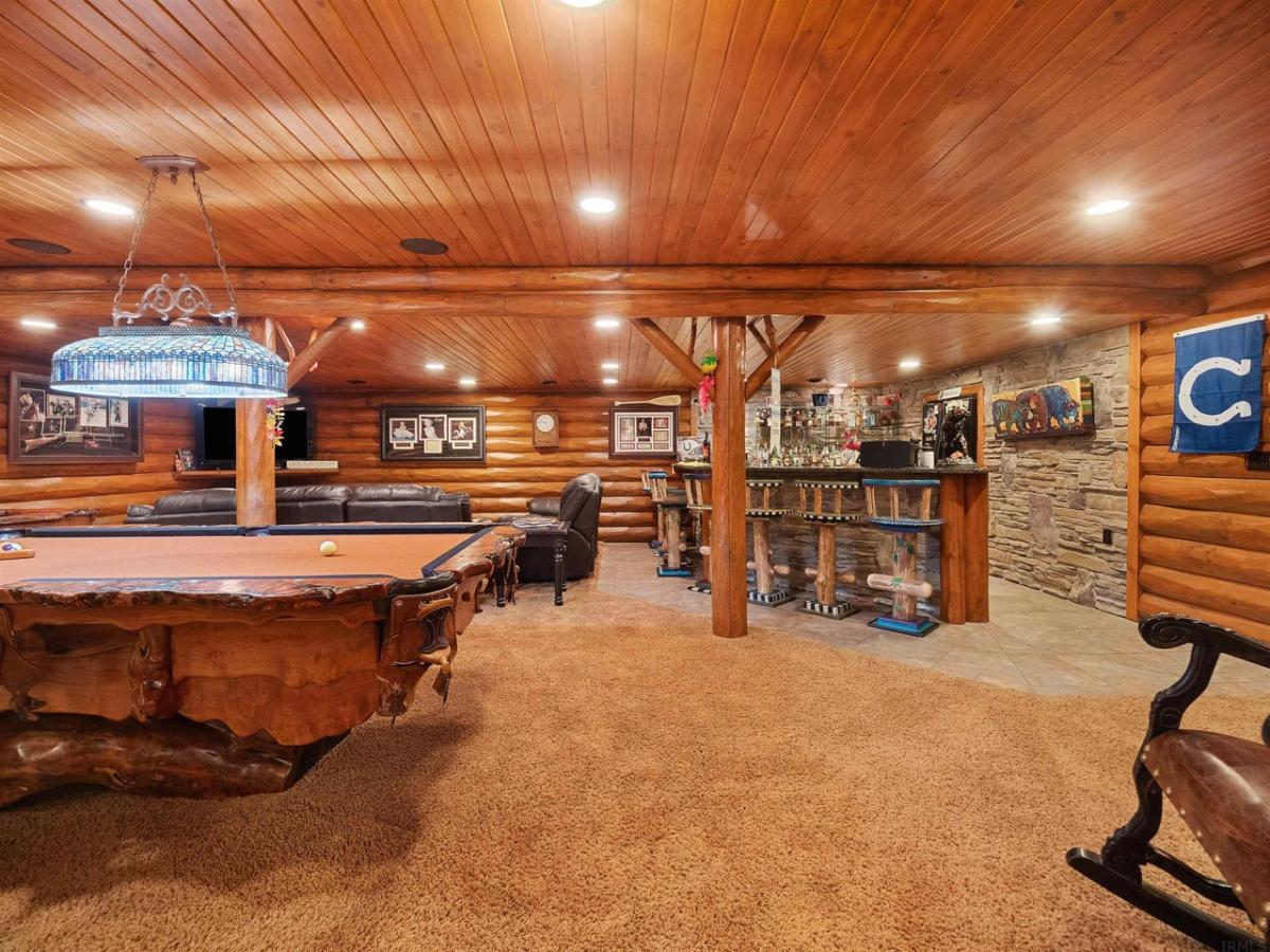 Entertainment room with custom lights and a pool table.