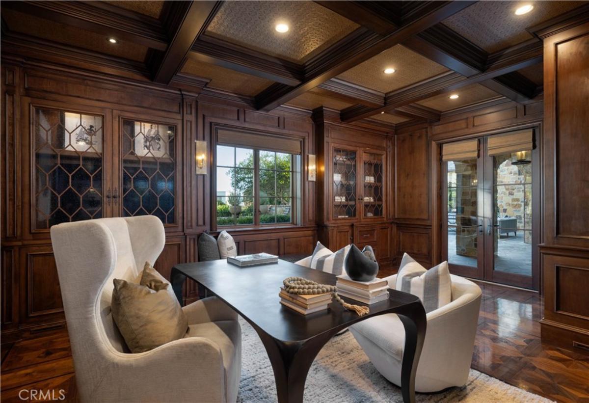 Home office with a desk, chairs, custom lights and a wooden floor.