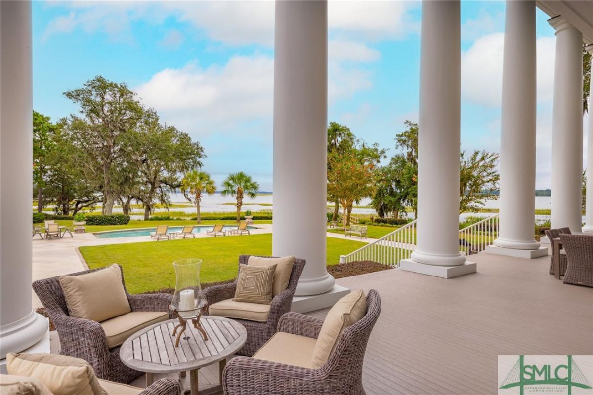 Porch with a table and chairs.