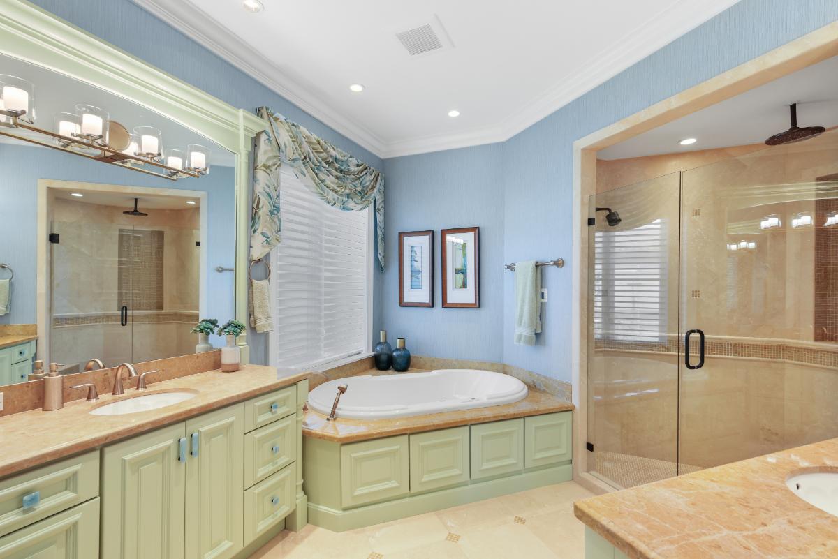 Bathroom with a sink, mirror, soaking tub and a walk-in shower.