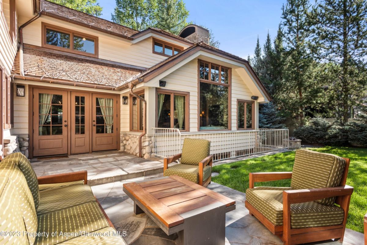 Patio with a couches, table and chairs.