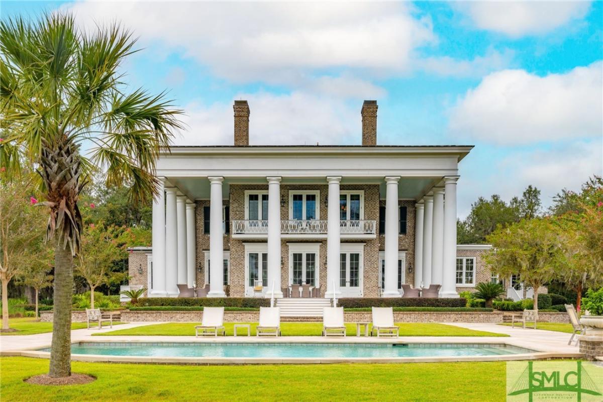 Rear view of the mansion with a pool.
