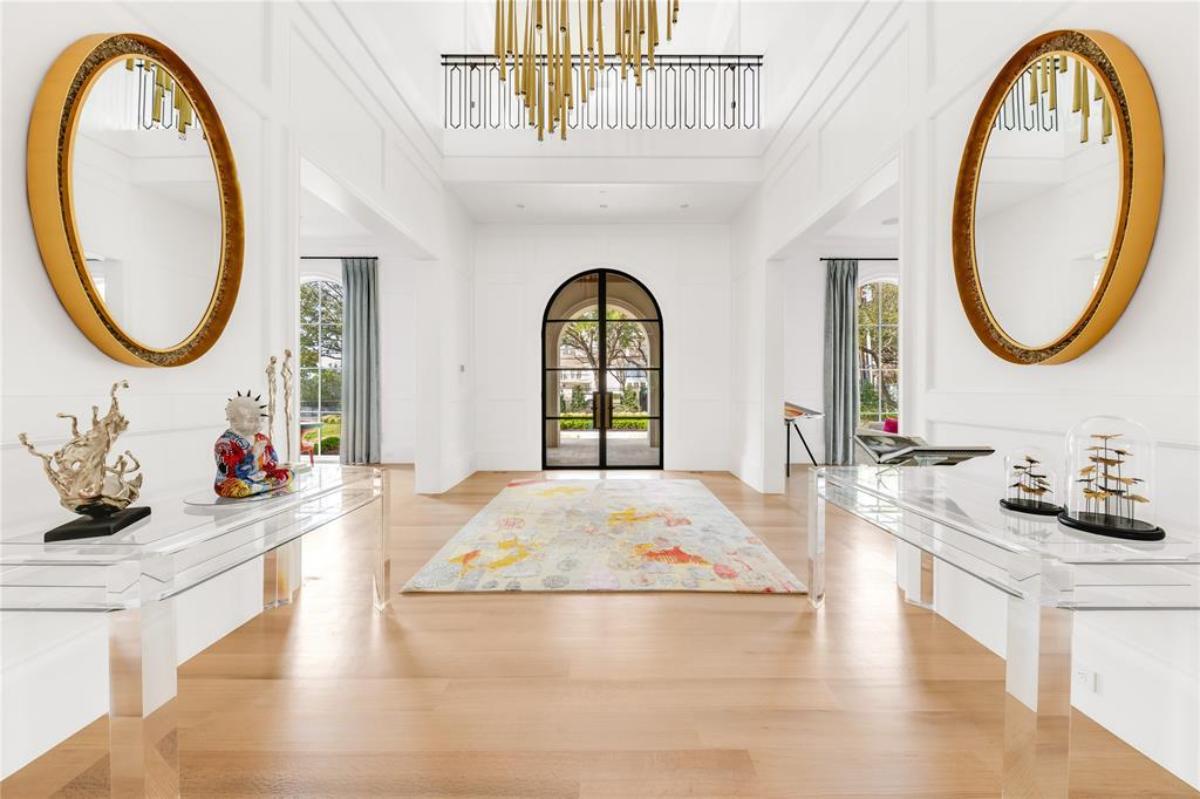Foyer with wood flooring and a chandelier.