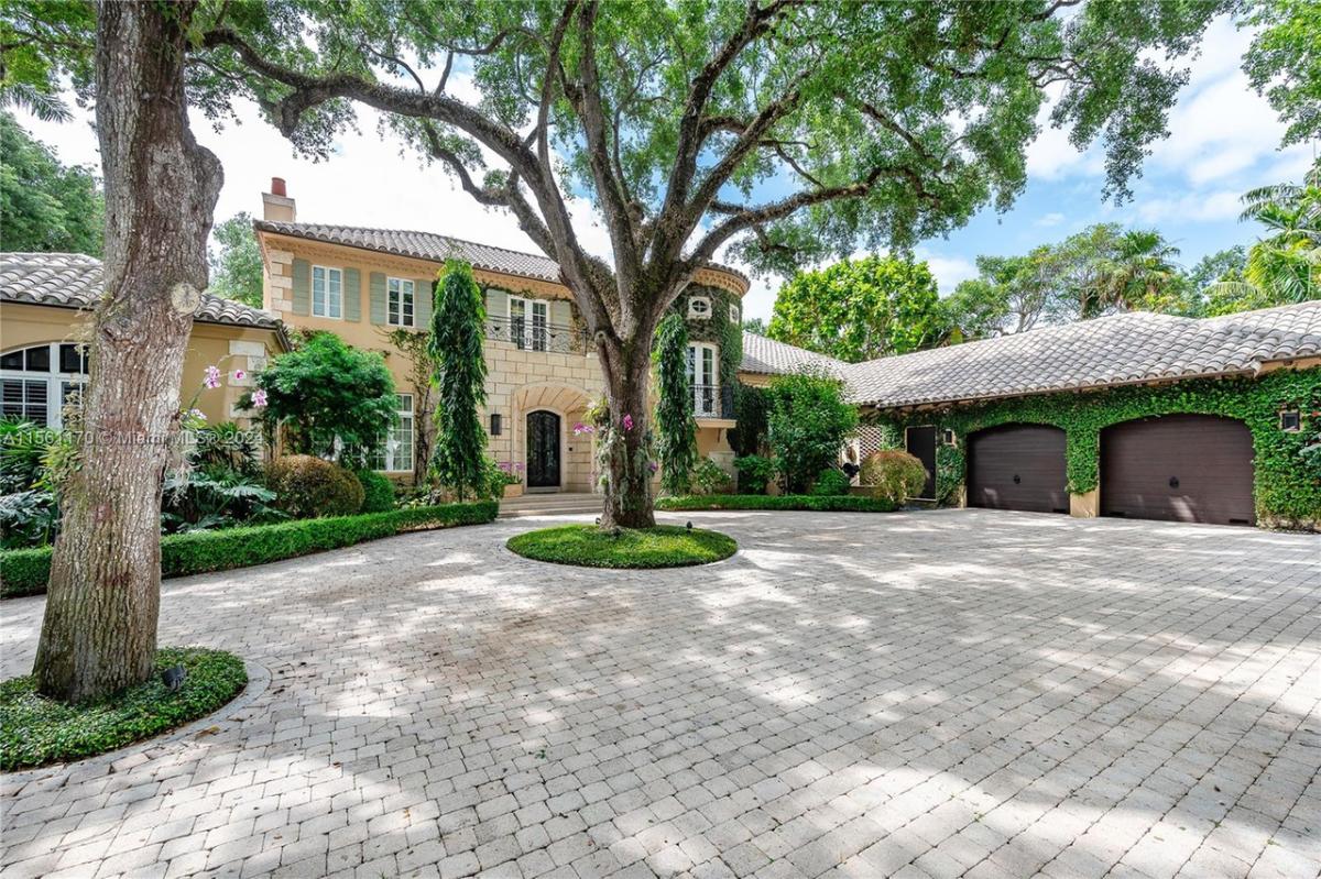 Front view of the house with a garage and spacious driveway.