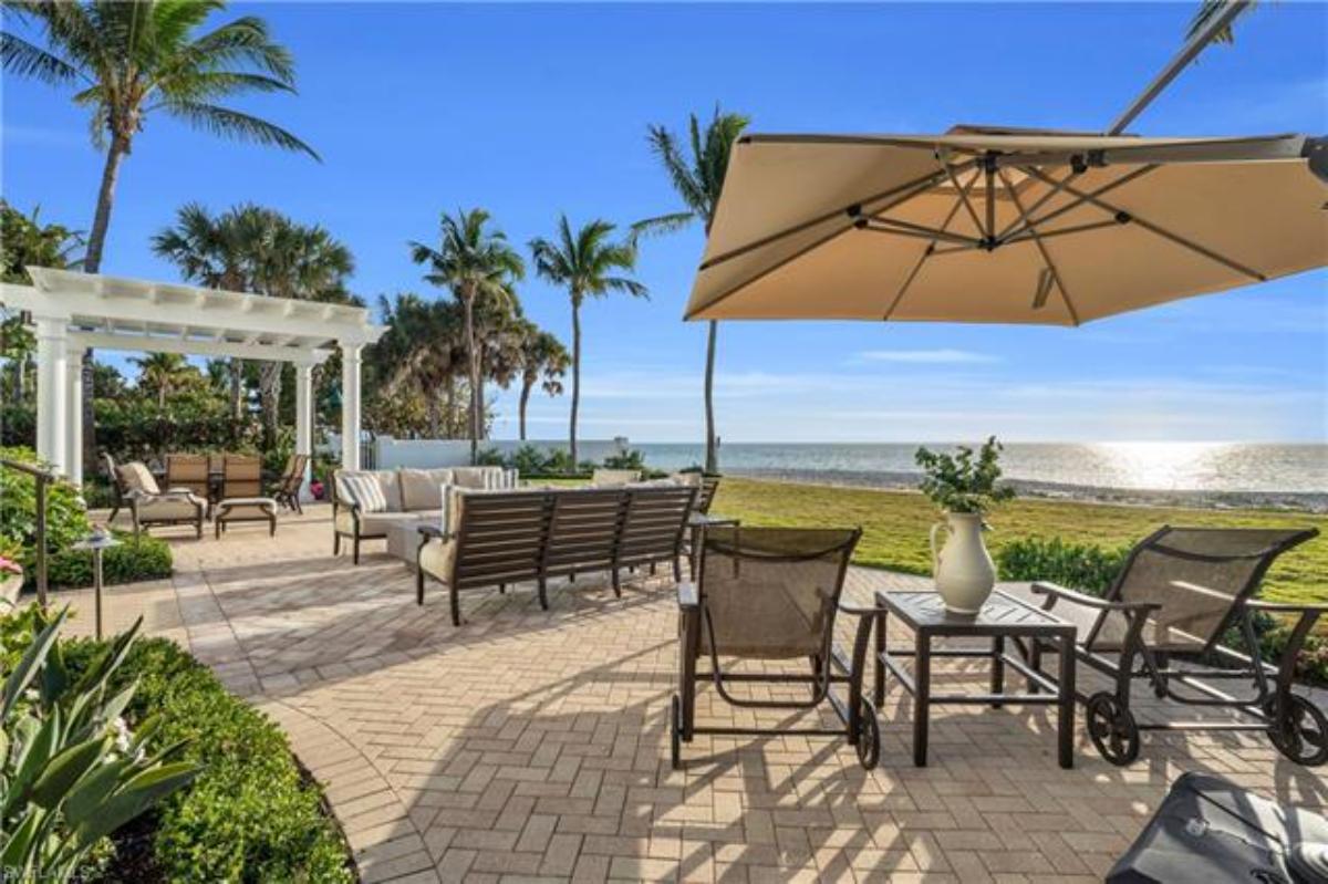 Patio with a table, chairs and a view of the waters.
