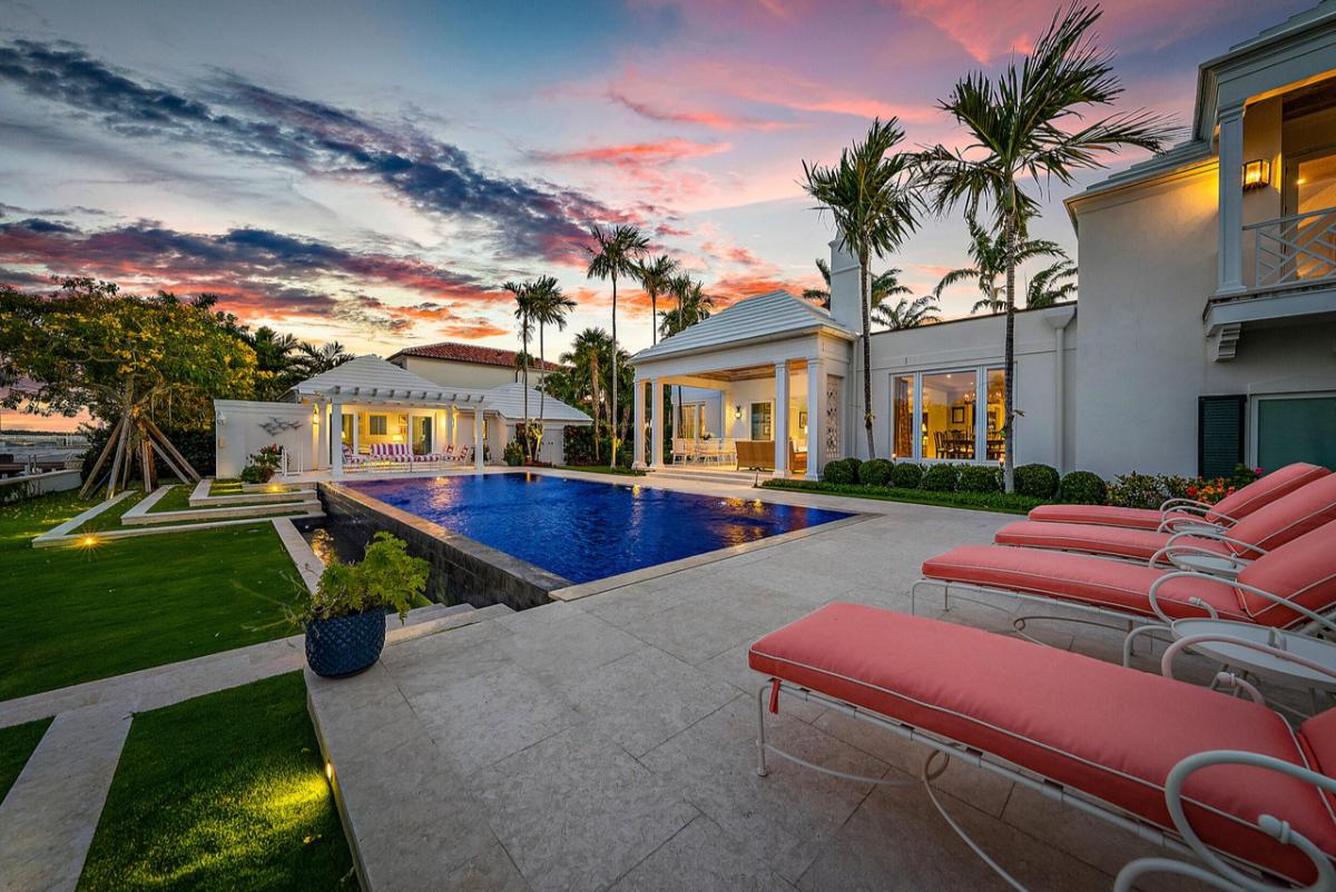Backyard with a swimming pool and lounge chairs. 