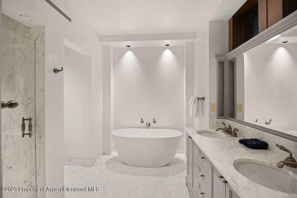 Bathroom with dual sinks, soaking tub and a shower.