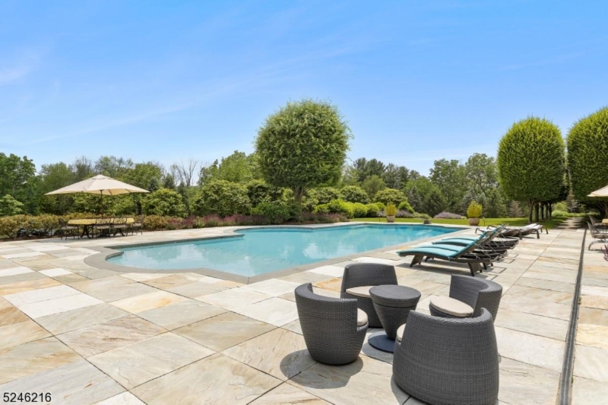 Pool with lounge chairs and a patio,