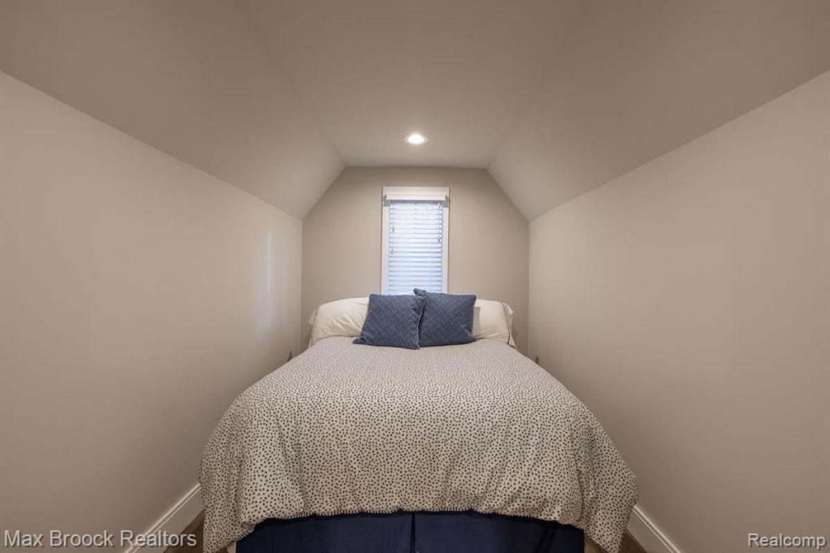Bedroom with a large bed and a glass window.