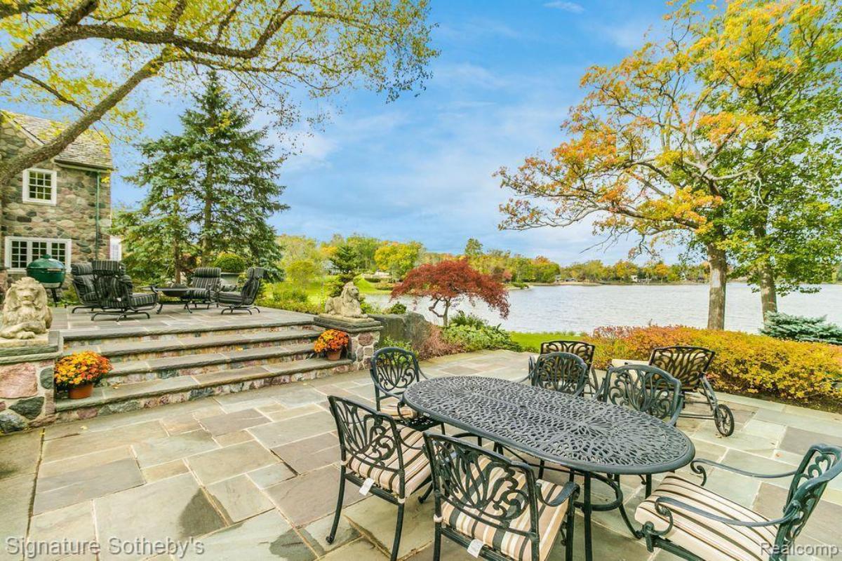 Patio with tables, chairs and overlooking the water.