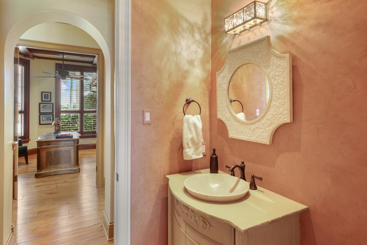 Powder room with a mirror and sink.