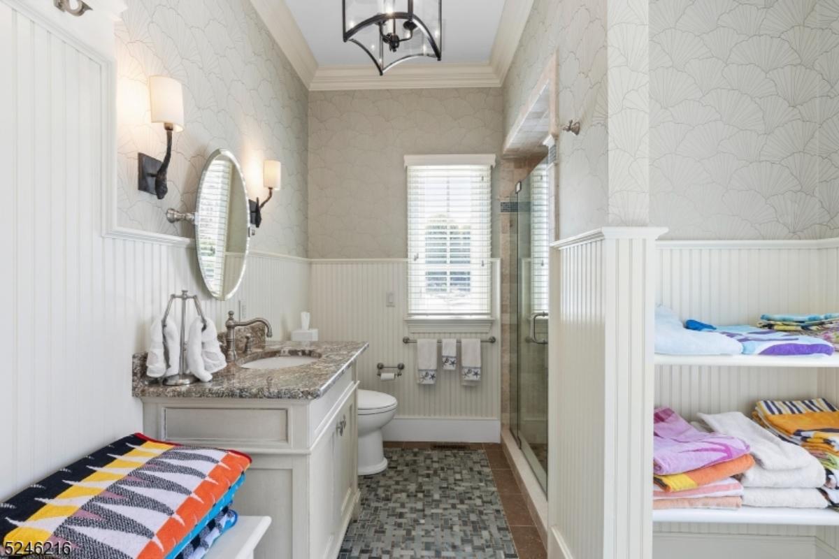 Bathroom with a sink, toilet, and a mirror.