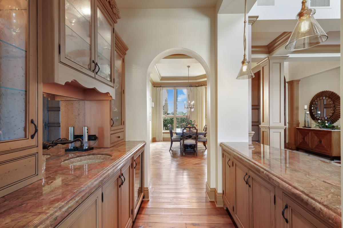 Pantry with marble counter tops and custom cabinets.