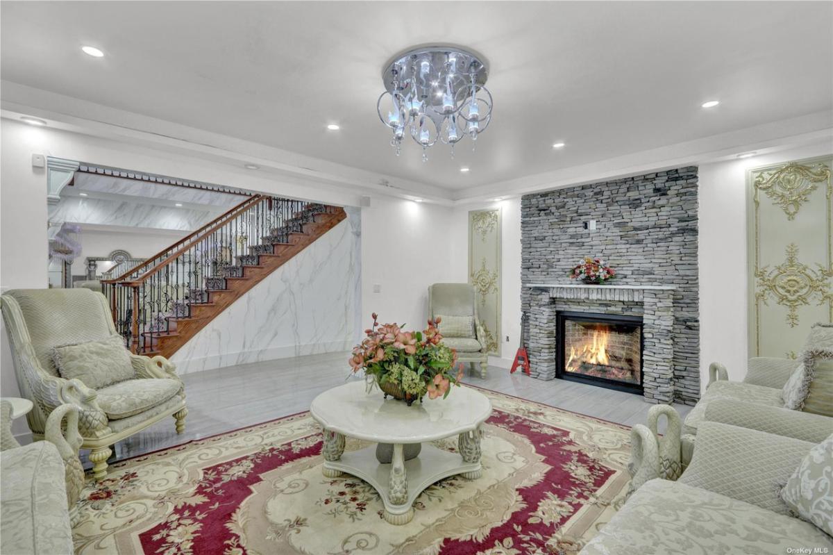 Living room with a chandelier and a fireplace.
