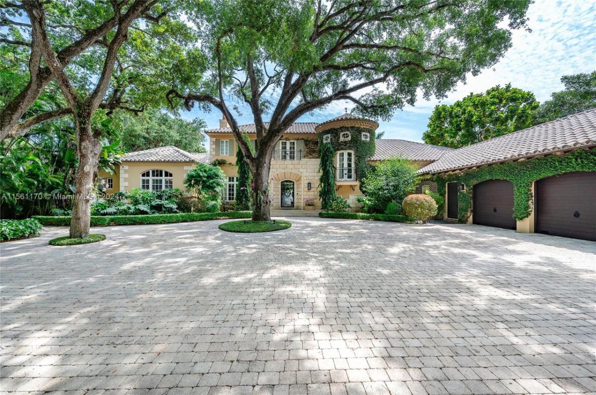 Front view of the house with a garage and spacious driveway.