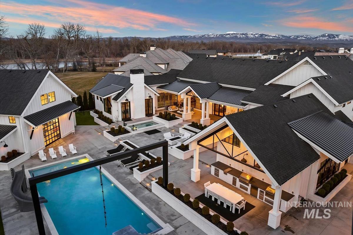 Aerial rear view of the mansion with a pool.