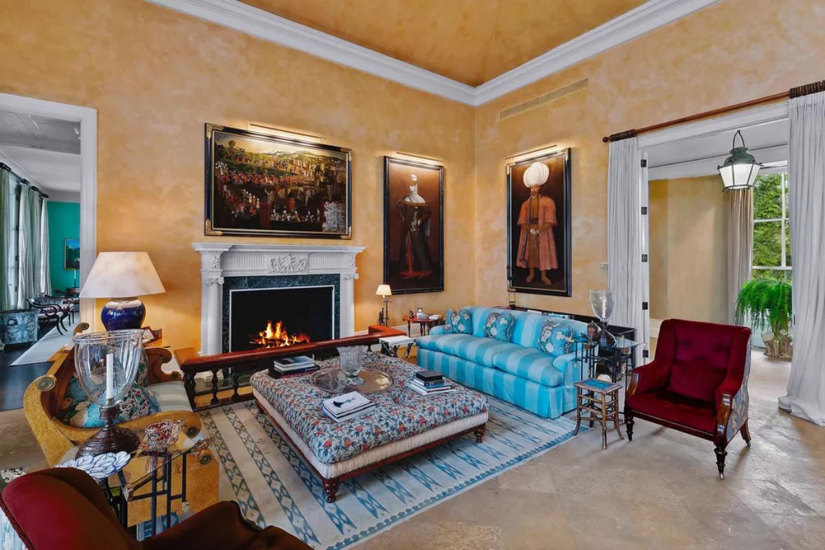 Living room with couches, fireplace and a large rug.