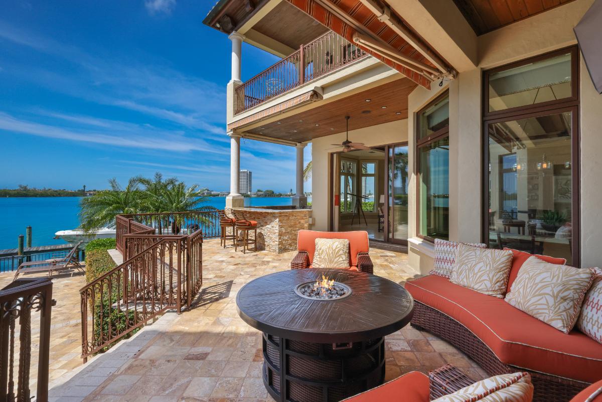 Patio with a fire pit and couches.