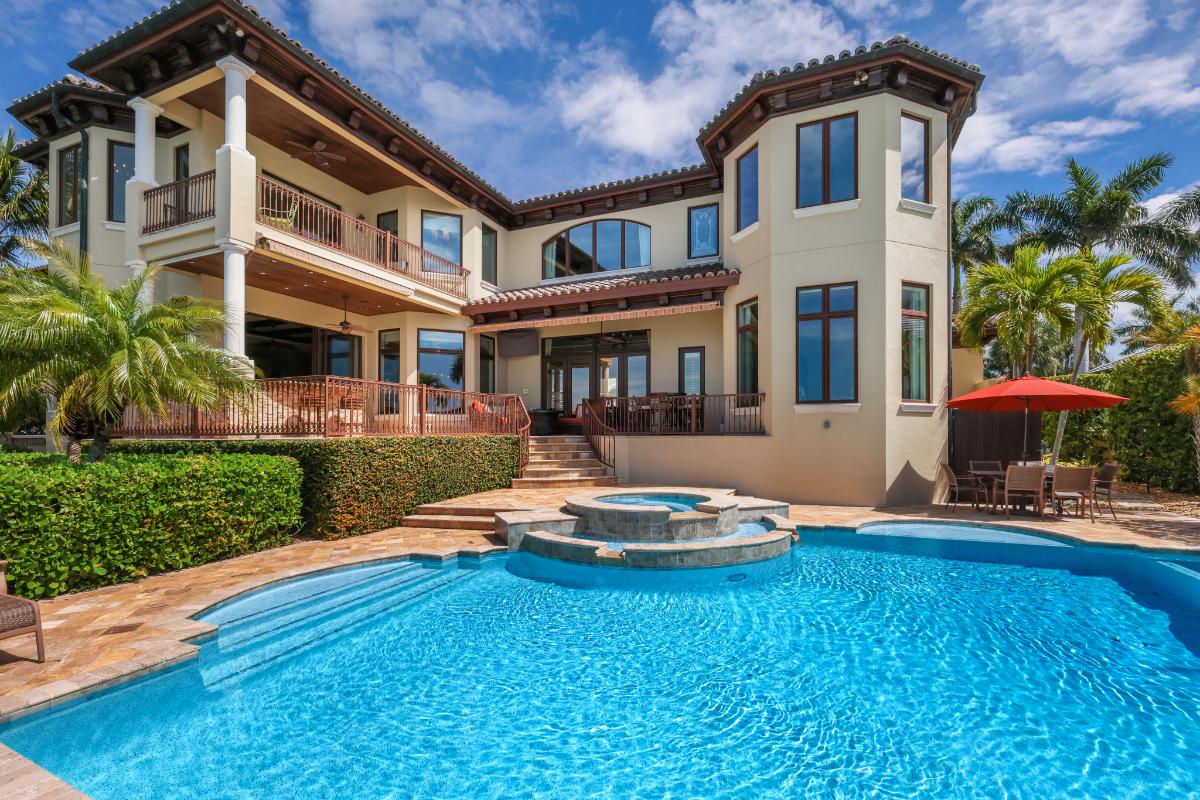 Rear view of the property with a pool.