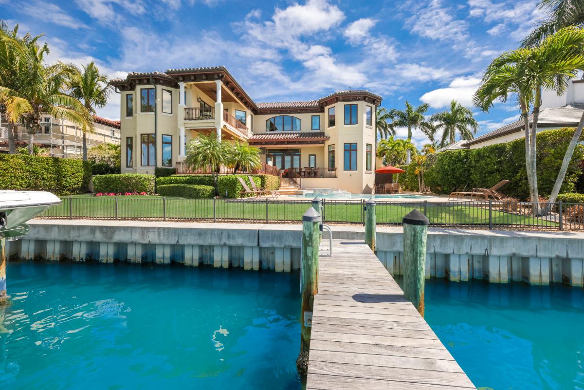 Backyard with a pool and a green lawn.