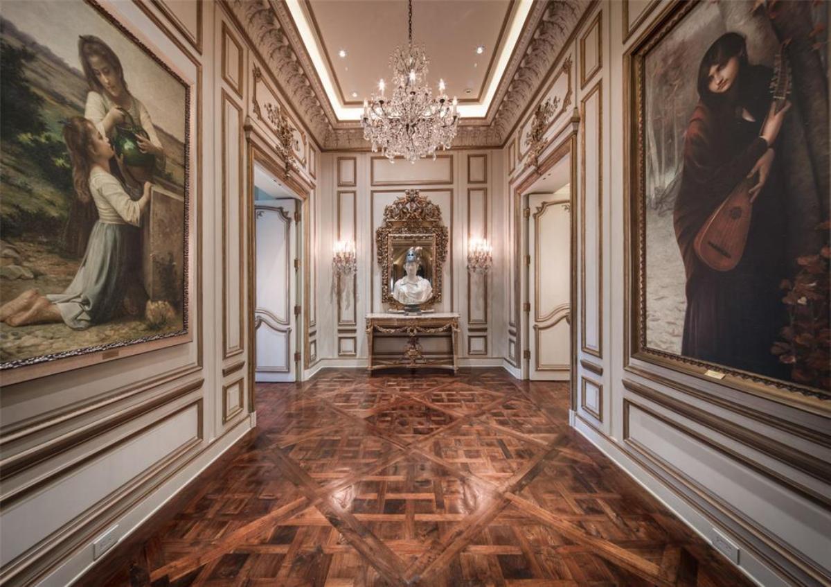 Hallway with a chandelier.
