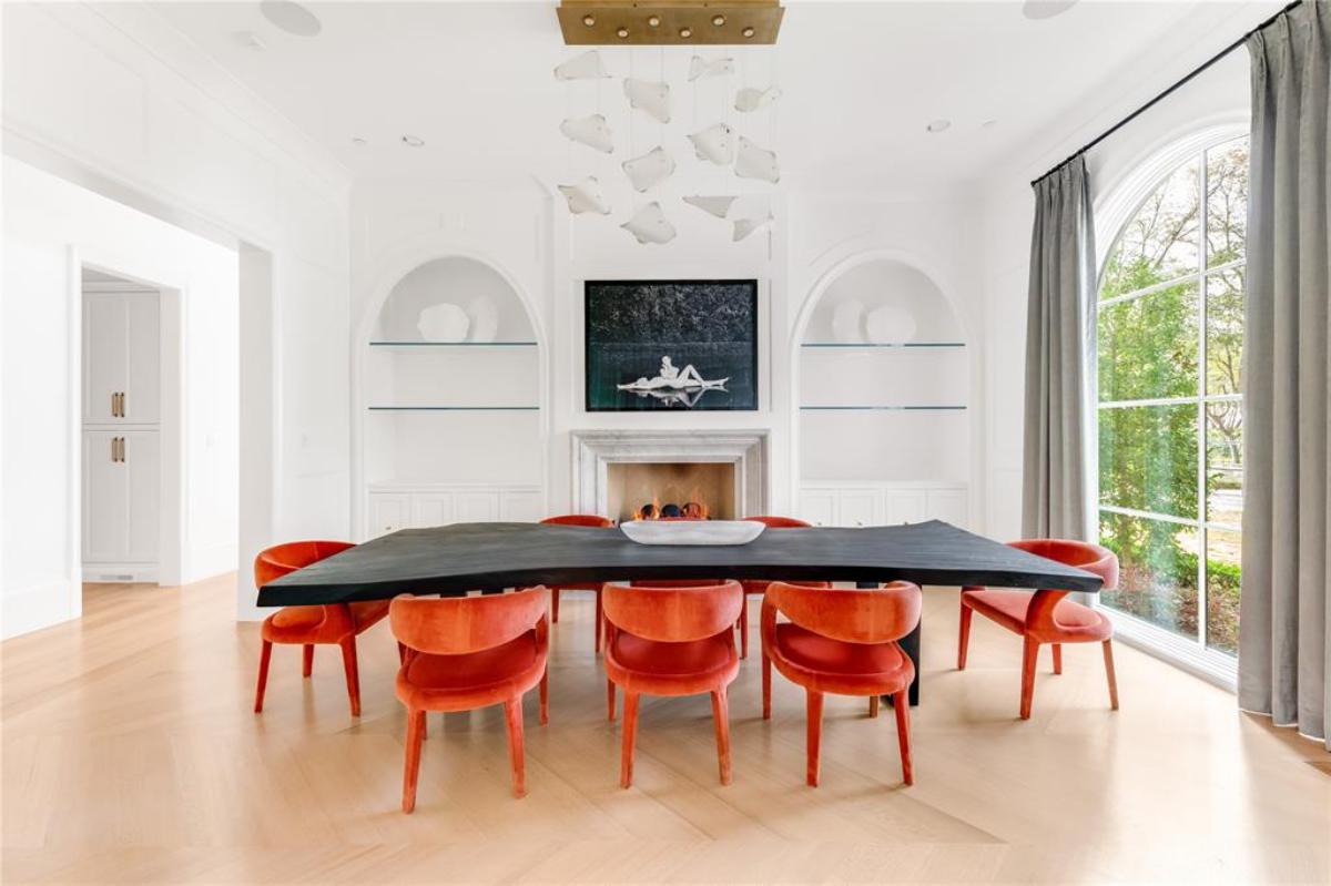 Dining room with glass windows and a fireplace.