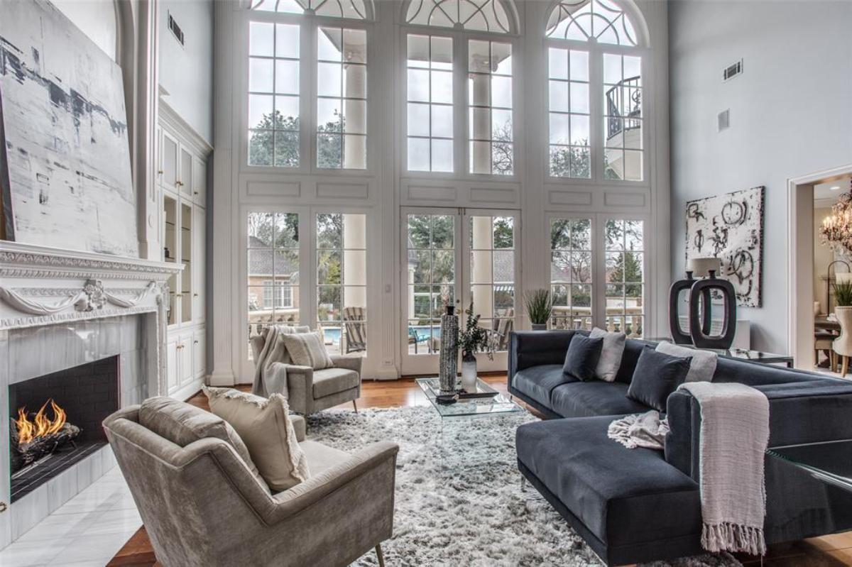 Living room with couches, glass doors and a fireplace.