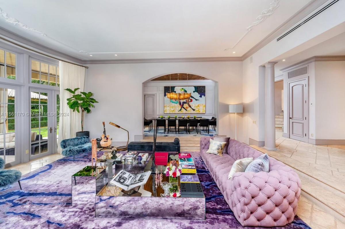 Living room with a couch, glass doors and custom lights.