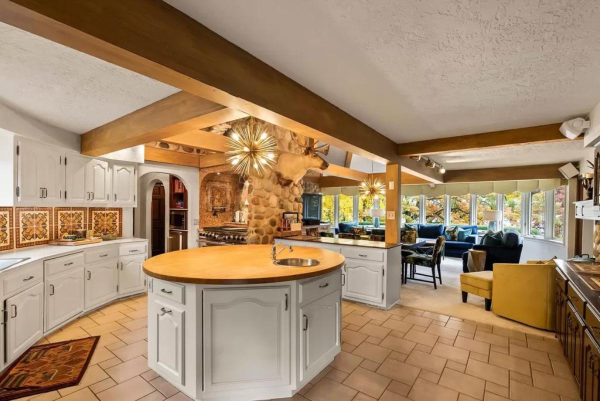 Kitchen with tile flooring and open beam ceiling.