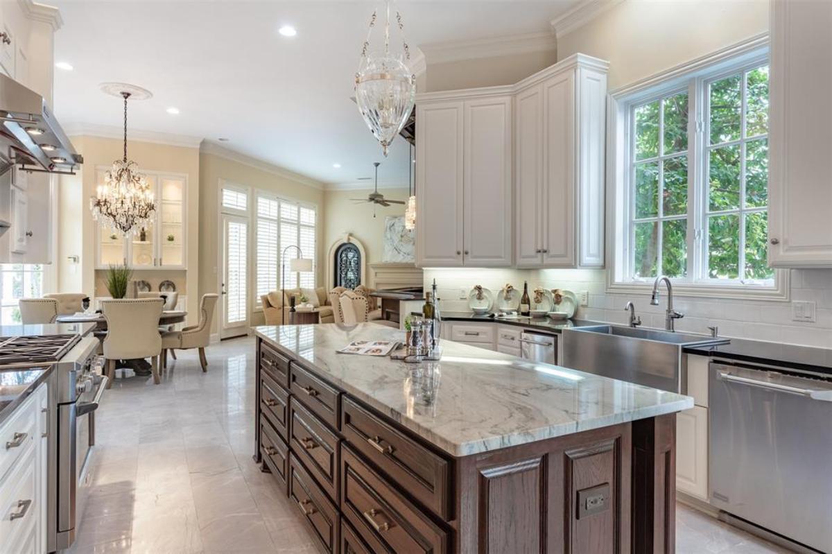 Kitchen with granite countertops, tile flooring and custom cabinetry.