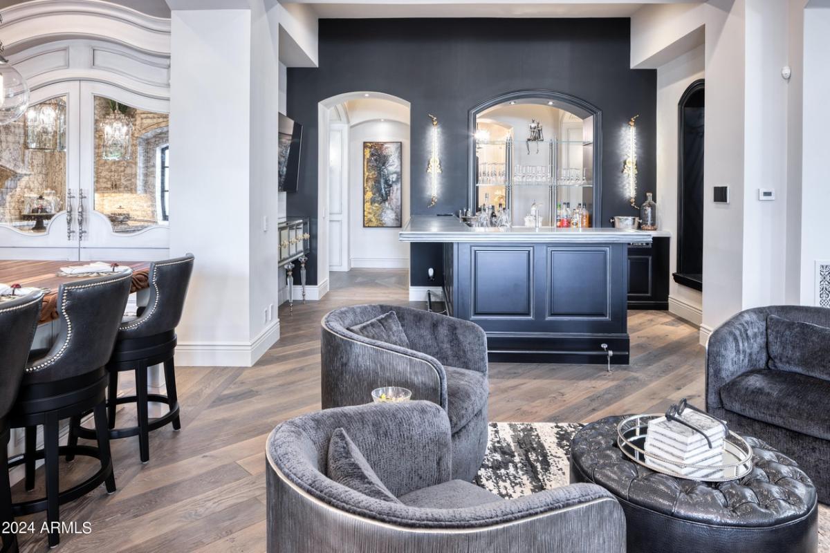 Bar with chairs, table and custom lights.