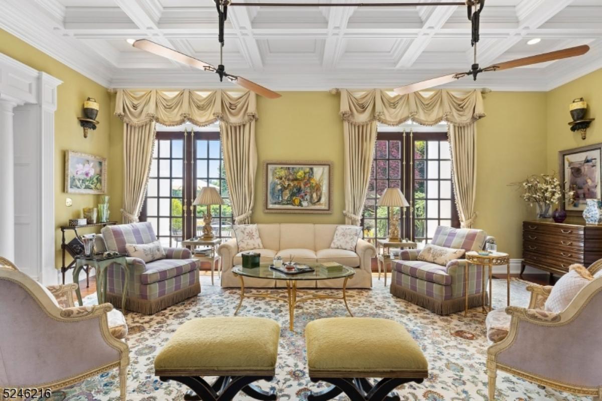 Living room with a couch, chairs and glass doors.