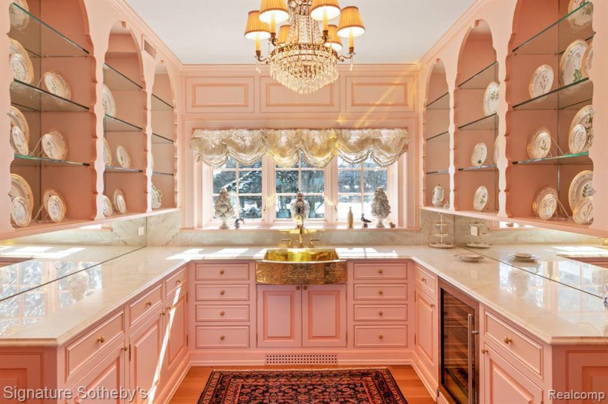 Kitchen with a chandelier and a pink chandelier.