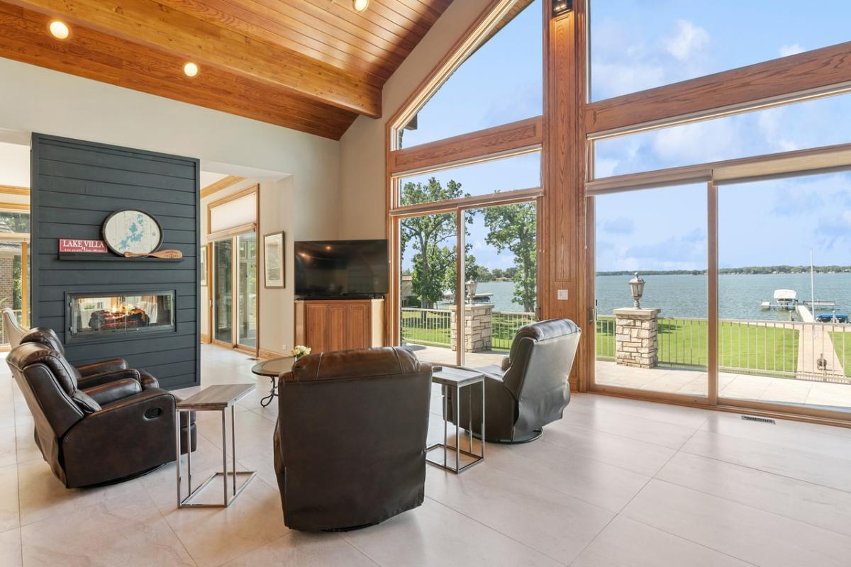 Living room with couches, TV and a fireplace.