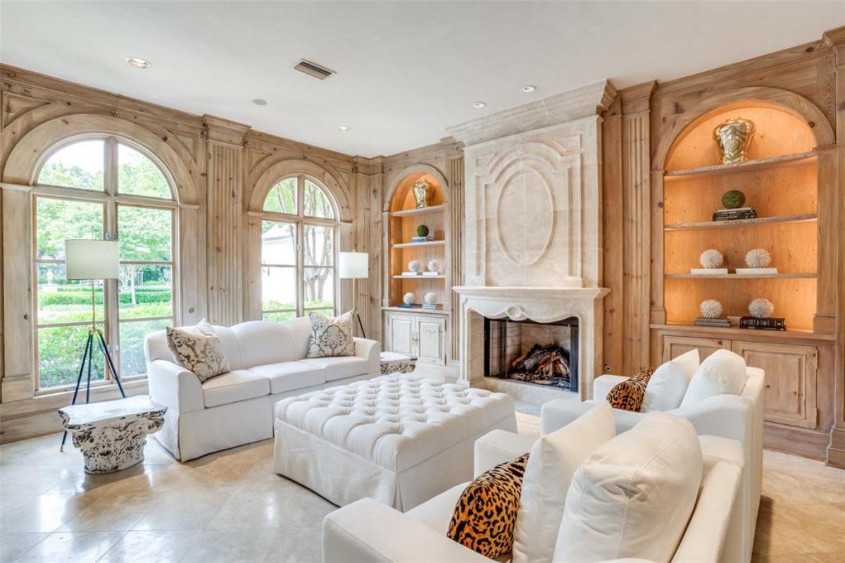 Living room with couches, custom lights and a fireplace.