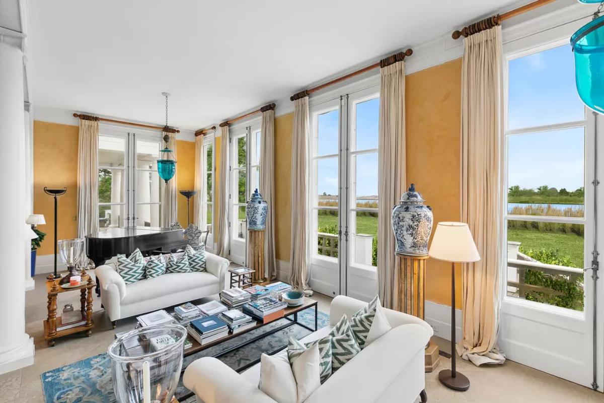 Sitting area with a couches, pillows and glass doors.