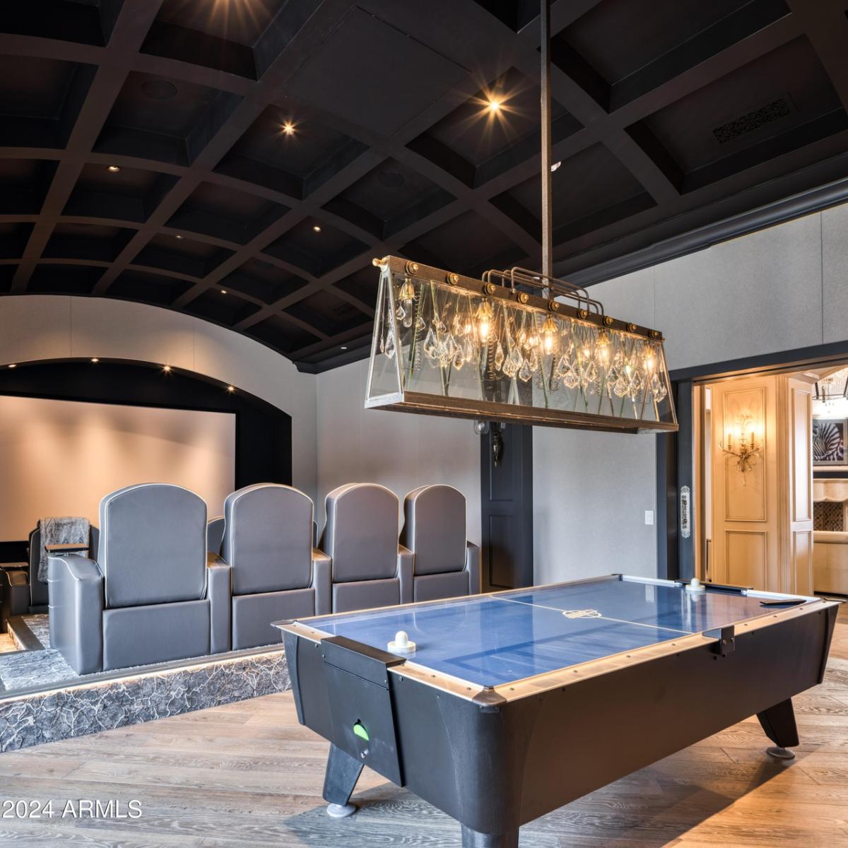 Home theater with a large screen, table hockey and custom lights.