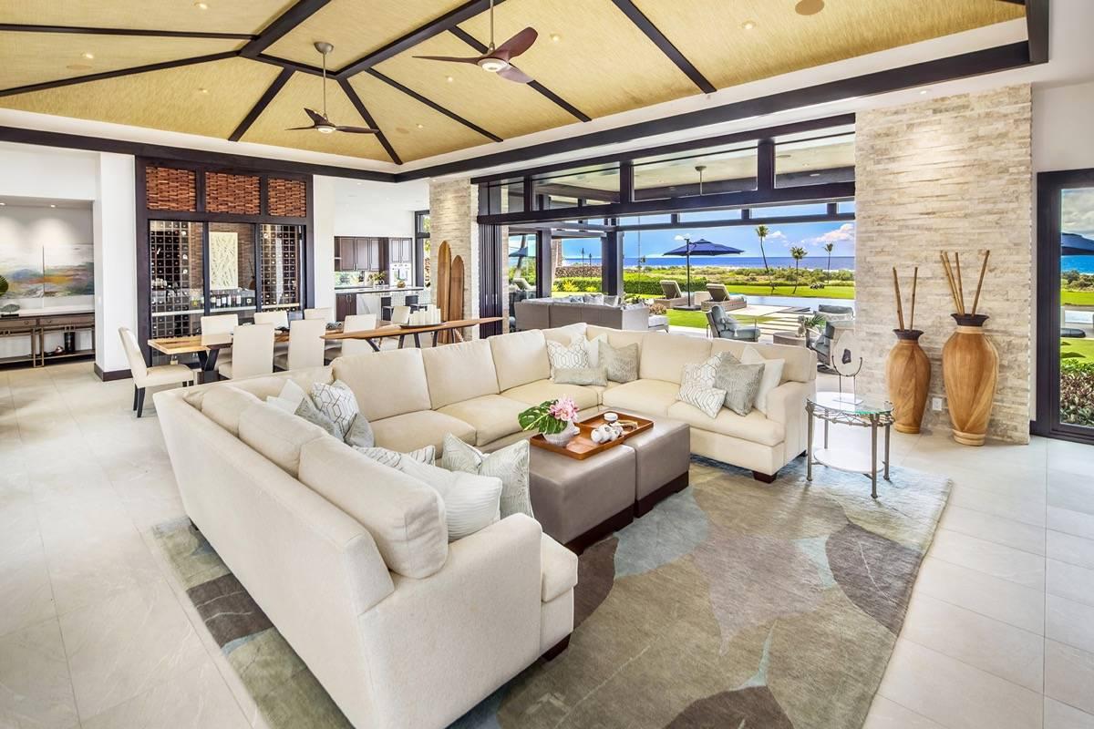 Great room with a living area, dining area and a wine cellar.